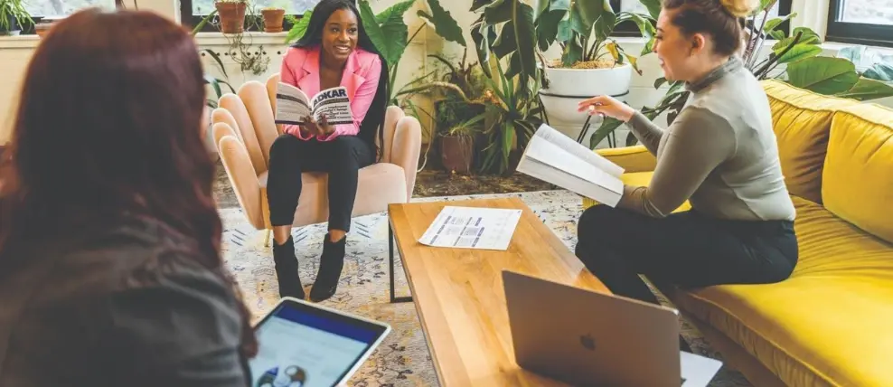 Three people in an office discussing